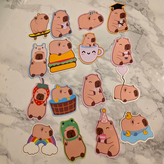 Set of cartoon Capybara stickers on a marble surface